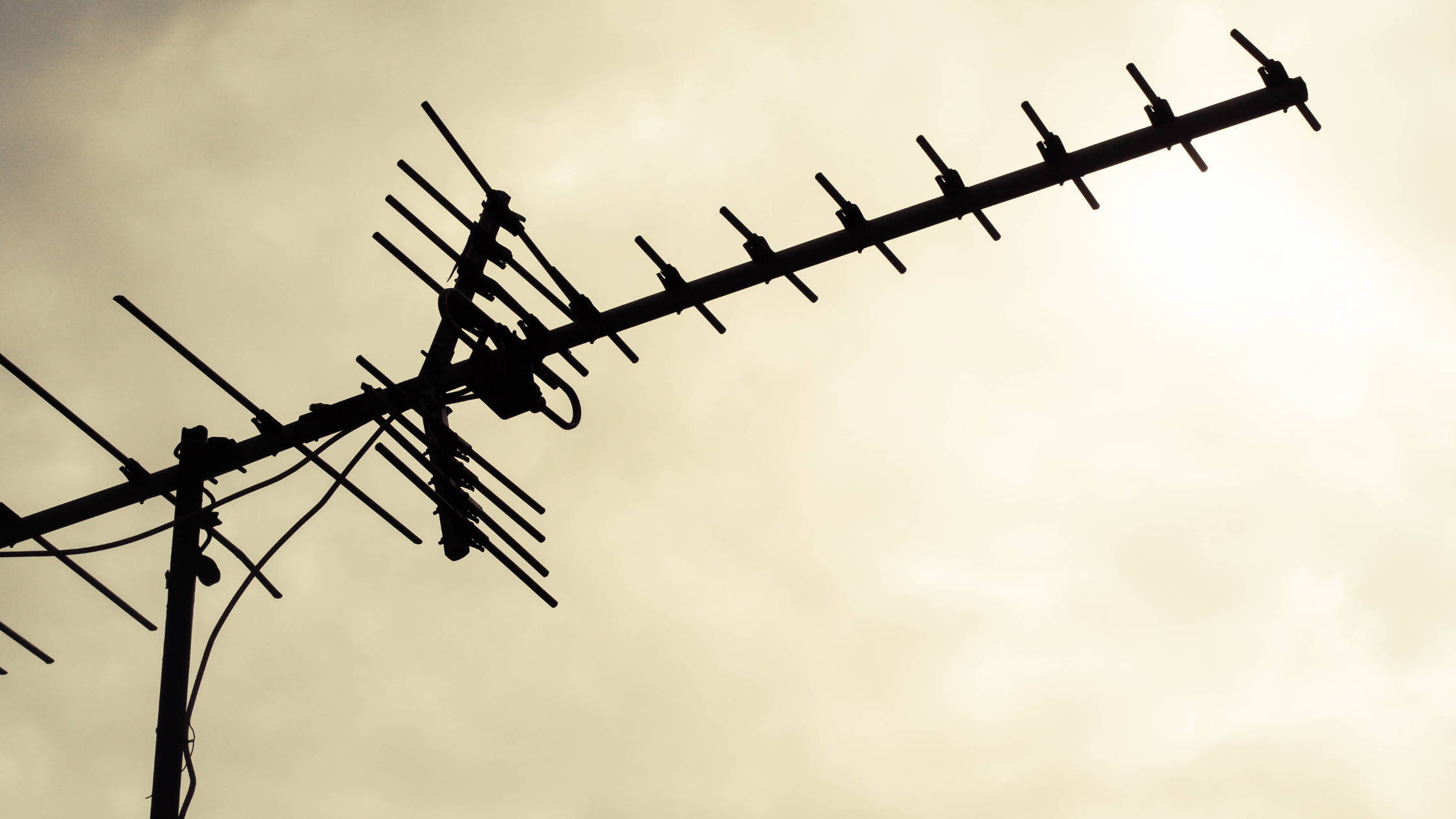 Outdoor TV antenna mounted on rooftop showing signs of wear and corrosion, needing replacement