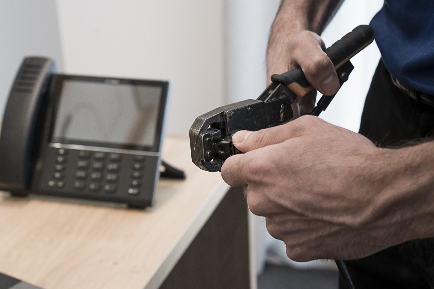 Technician preparing and crimping TV antenna cabling during HD antenna installation