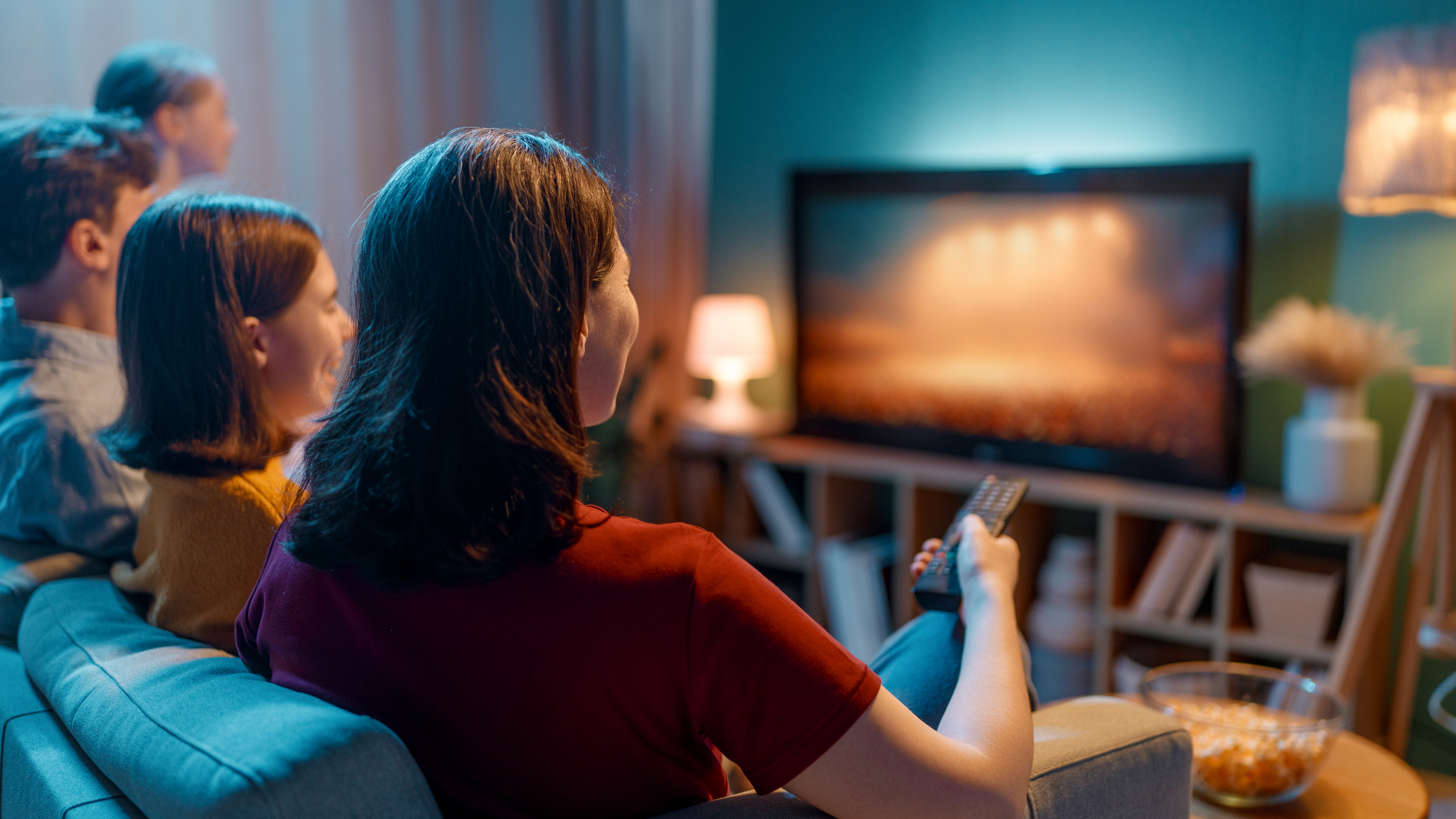 Family watching television in living room with stable signal, representing sudden tv reception not working issues in modern homes