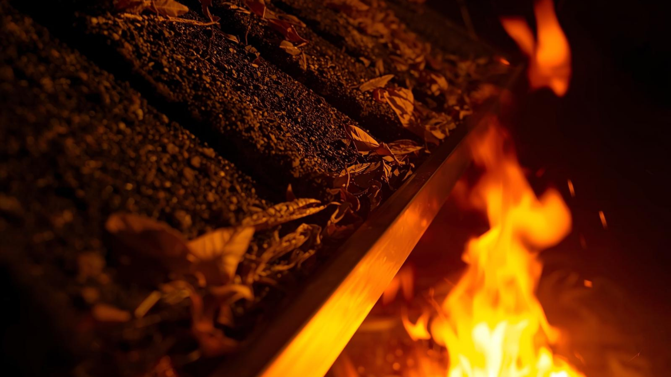 Dry leaves in roof gutters igniting during a bushfire ember attack